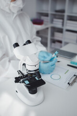 Lab practitioner working on chemical research for chemical reactions, does a chemical experiment and examines a patient's blood sample. Medicine and research concept.