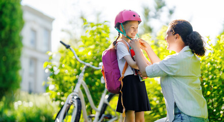 Girl in safety helmet with mother