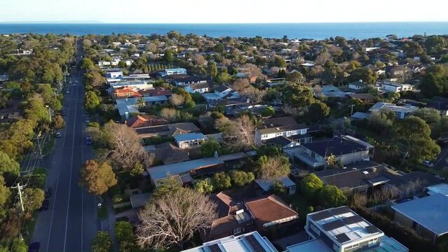 4k drone video above Mentone suburban flying forward to reveal the sea