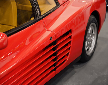 Red oldtimer sportscar. Coupe from 1980s with side vent slots on the sides