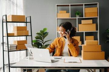 Small business entrepreneur SME freelance African woman working at office, BOX,tablet and laptop...