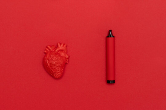 Red heart and electronic cigarette vape on red background. Horizontal medical theme poster, greeting cards, headers, website and app