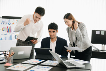 Fototapeta premium Group of Young Asian business team creative businesspeople coworker, teamwork celebrating achievement and in planning design in creative