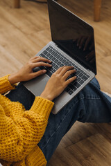 Fototapeta premium Young adult happy smiling Hispanic Asian student wearing headphones talking on online chat meeting using laptop in university campus or at virtual office. College female student learning remotely.