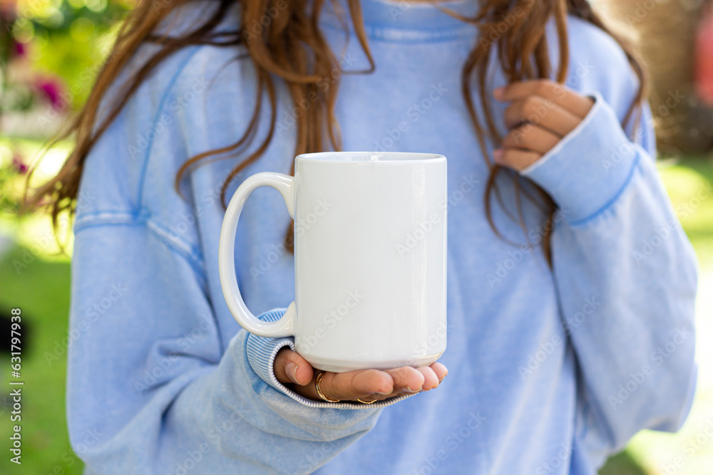Wall mural Girl is holding white mug in hands. Blank 15oz ceramic cup	 - Wall murals