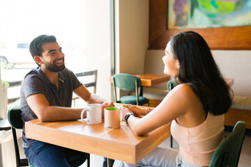 Happy man talking with his girlfriend at the coffee shop