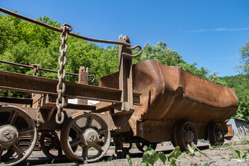 Fototapeta na wymiar Old rusty train wagon forever parked at an abandoned railway station used for excavation of charcoal from underground mine, near Despotovac city, Serbia