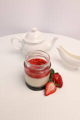 Panna cotta Italian dessert with strawberries on a light background