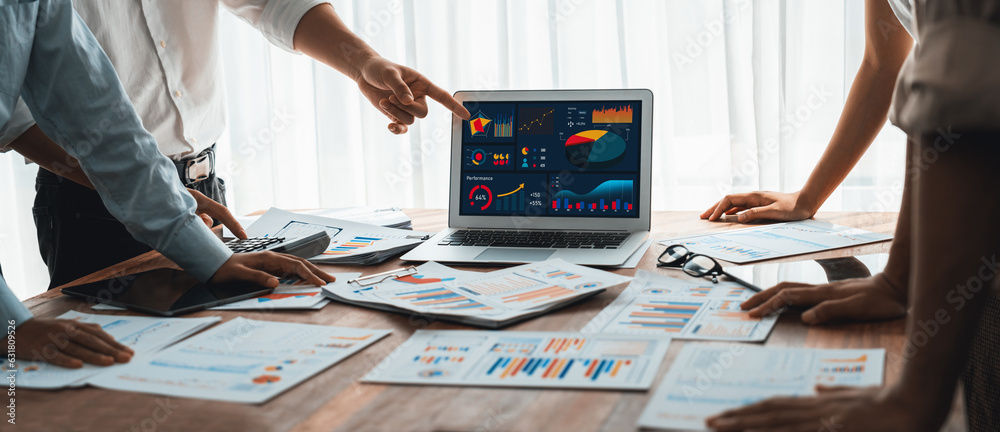 Poster Panorama shot analyst team utilizing BI Fintech to analyze financial report with laptop. Businesspeople analyzing BI power dashboard displayed on laptop screen for business insight. Scrutinize