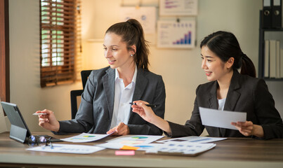 Asian businessmen, women and men Talk about new projects, presents at home office.