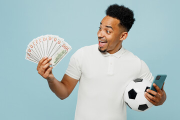 Young man fan wear t-shirt use mobile cell phone hold in hand fan of money cheer up support...