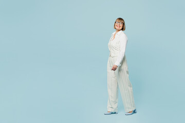 Full body side view smiling employee business woman 50s wears white classic suit glasses formal...