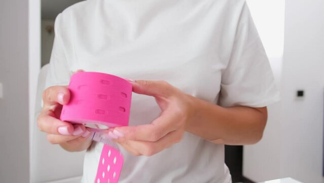 Kinesiology tape in woman's hands. Kinesiology taping concept. Health care concept