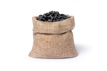 Fototapeta na wymiar Black beans (Urad dal, black gram, vigna mungo) in hemp sack bag isolated on white background.