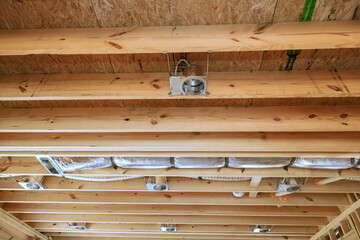 Fototapeta na wymiar Installing of central conditioning set hvac system spotlight in new home on wooden beamed ceiling