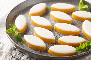 Calissons French glazed almonds bonbons with white icing closeup on the table. Horizontal