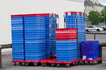 Plastic pallets stacked outside supermarket in car park