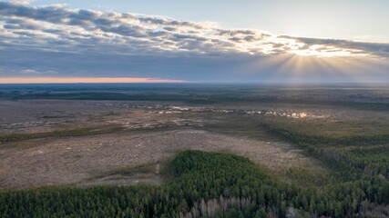 View of a breathtaking sunset over a grassy plain dotted with trees