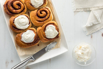 Top down view of cinnamon buns with two unfrosted.