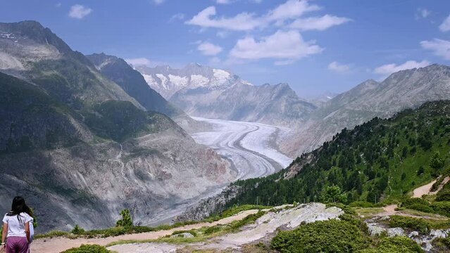 Children hiking at mountain. Landscape of glacier, mountain and forest. Aletsch Glacier in Swiss Alps. Riederalp, Valais Canton, Switzerland. Travel destinations. 
