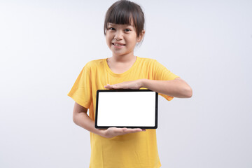 Little girl holding up a blank tablet computer isolated on white background