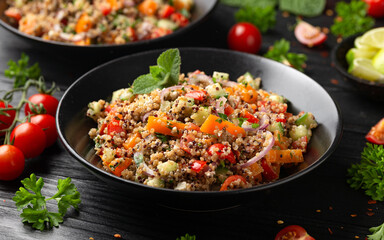 Red and white quinoa tabbouleh salad with tomatoes, paprika and mint. Vegetarian, vegan food concept