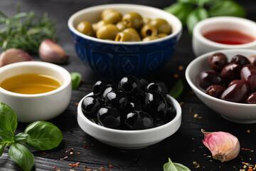 Assortment of fresh green, kalamata and black olives in bowl. Healthy snack