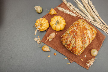 Fresh bread with pumpkin seeds. Home baking concept. Autumn decor