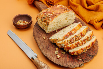 Fototapeta na wymiar Fresh bread with pumpkin seeds. Home baking concept. Autumn decor