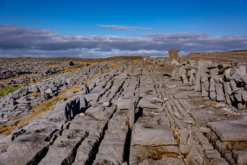 Stone field on  cloudy blue sky day near Black Fort on Inishmore island, Galway, Ireland