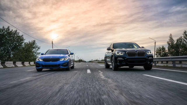 Seattle, Washington, USA, August 4, 2023 BMW x4 black and BMW 3 blue. Driving on the highway