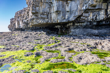 Amazing colorful rocks by the wormhole at the cliff on Inishmore island, Galway, Ireland