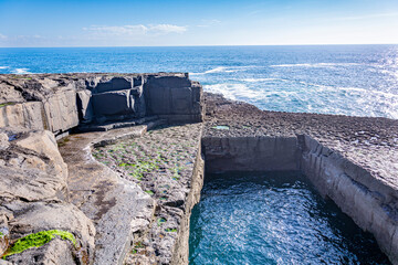 On the edge of the  wormhole at a cliff on Inishmore island, Ireland