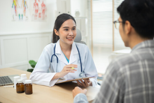 Asian Woman Doctor talking to patient at the clinic or hospital.