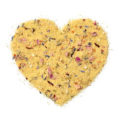 Couscous with dried flowers in heart shape isolated on white background