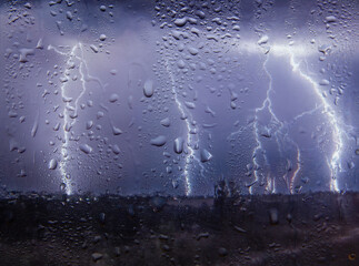 Outside the window, lightning, rain and wind, view from the window