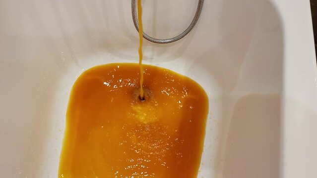 The faucet in the bathroom is dispensing brown, dirty water that's been tainted with rust from the plumbing.