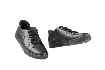black leather sneakers on a white background