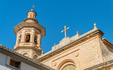 Obraz premium Bell tower and church against blue sky in Xaló (Alicante, Spain)