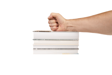 a male fist on top of a stack of books