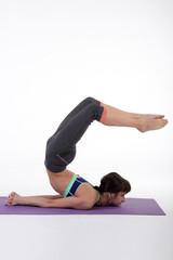 Woman doing yoga in photo studio on isolated white background.	
