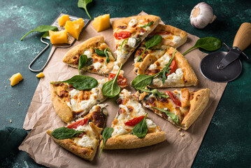 Italian pizza with feta cheese, tomato and basil