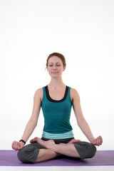 Fototapeta premium Woman doing yoga in photo studio on isolated white background. 
