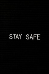 Vertical black spongy board with a text "stay safe" for background