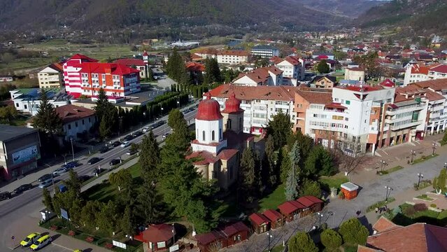 Aerial footage of the old stone church of Biserica Adormirea Maicii Domnului in Targu Ocna
