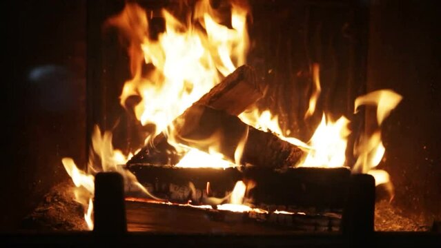 Closeup footage of burning wood in a fireplace. Golden flame burning the material