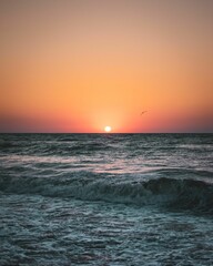 Sunset view in the orange sky from the sea.