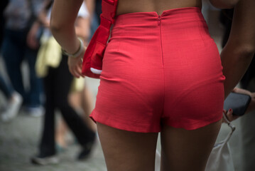 Closeup of mini red short on woman in the street