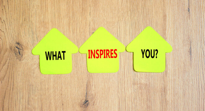 What inspires you symbol. Concept words What inspires you on beautiful yellow paper house. Beautiful wooden background. Business motivational what inspires you concept. Copy space.
