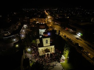 Aerial view of a church with people gathered in the yard